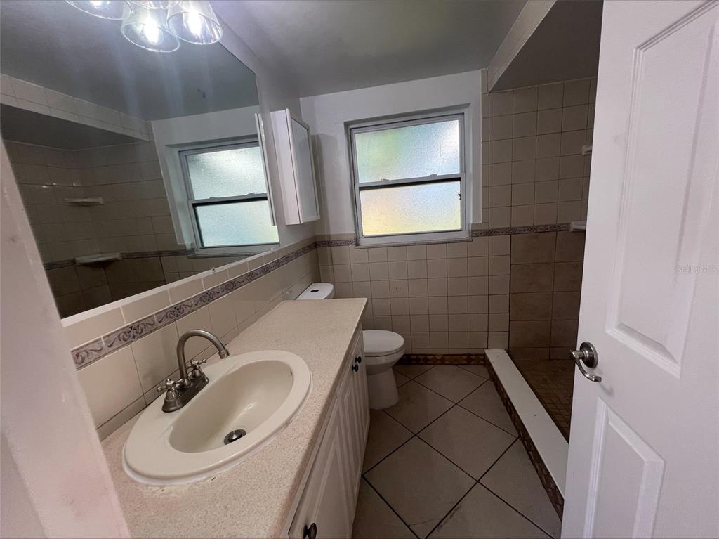 7539 Marechal Avenue Port Richey, FL 34668 - Photo 11 of 13 a bathroom with a sink and a mirror