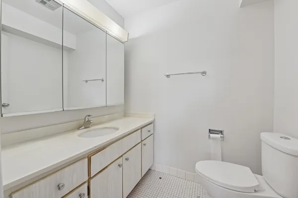 a view of swimming pool that has lawn chairs with plants and trees