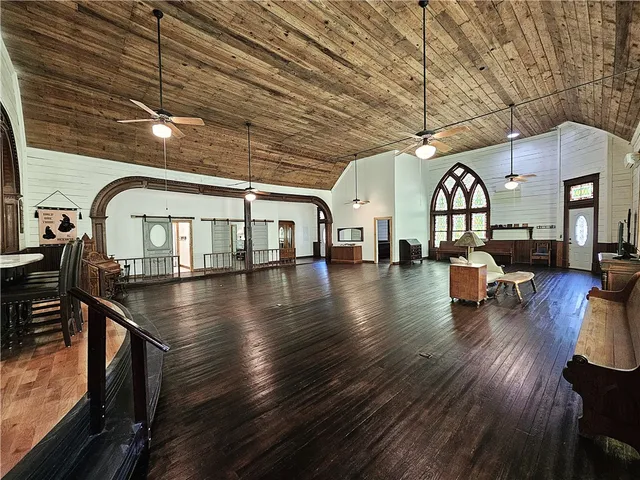 a view of hall with dining room and wooden floor