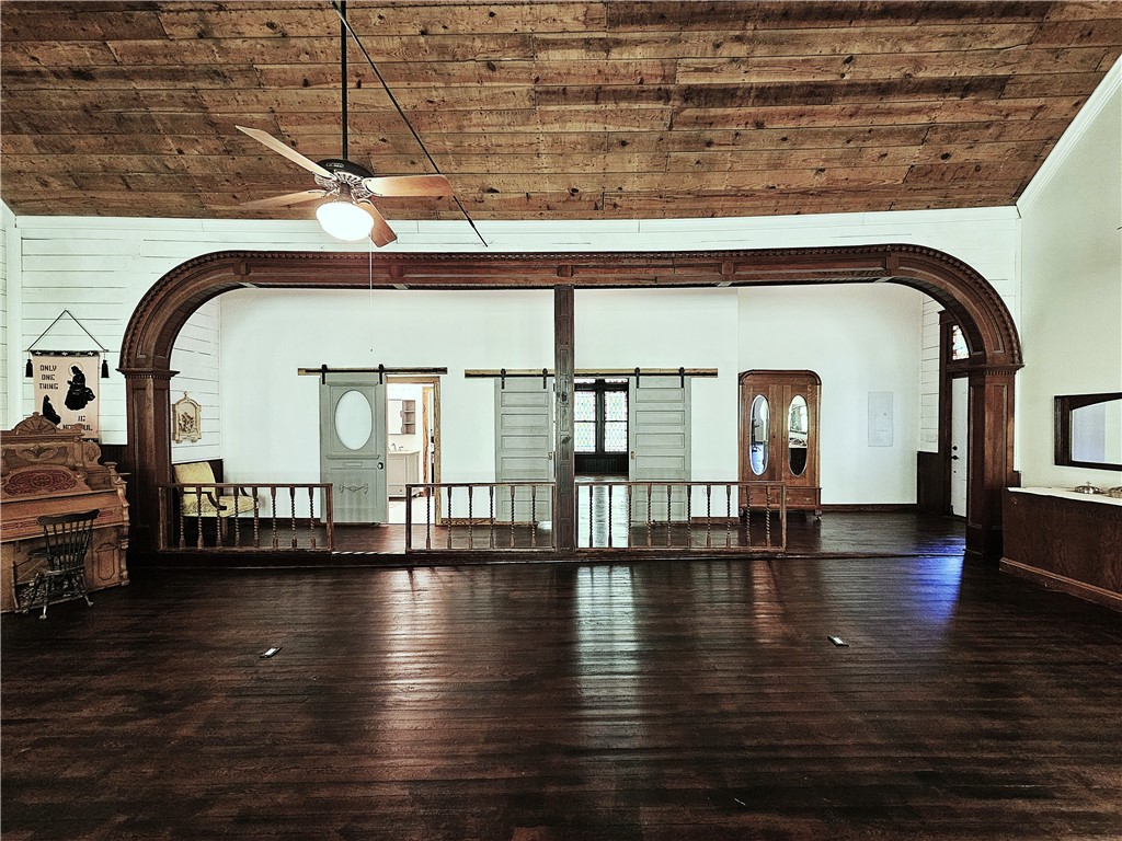 1100 South Tyler Street Thornton, TX 76687 - Photo 13 of 26 a view of hall with dining room and wooden floor