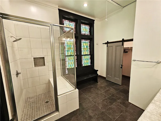 a bedroom with a bed a dresser next to a window