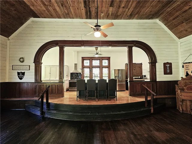 a kitchen with kitchen island a counter top space appliances and a window