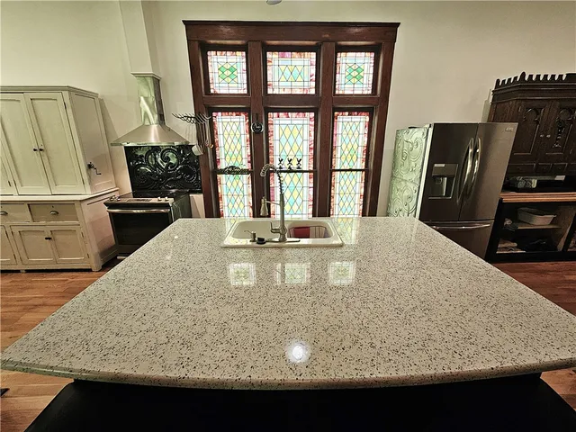 a hallway with table mirror and wooden floor