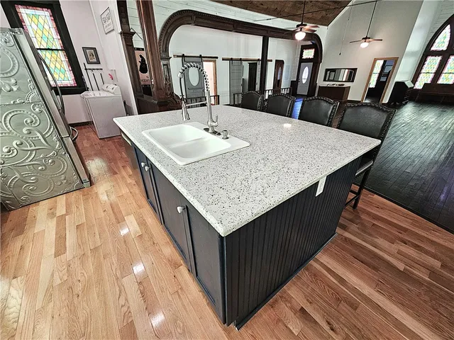 a kitchen with stainless steel appliances granite countertop a refrigerator and a sink