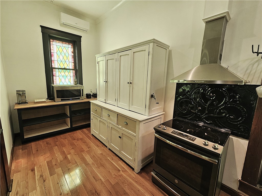 1100 South Tyler Street Thornton, TX 76687 - Photo 9 of 26 a kitchen with wooden cabinets and a stove top oven