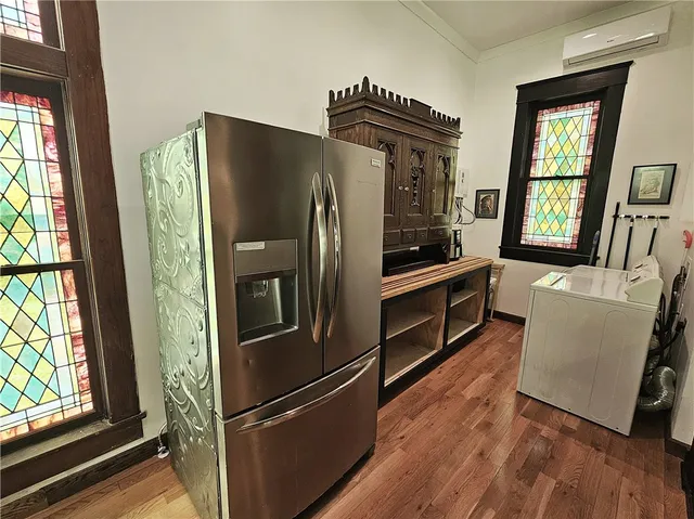 a view of a room with wooden floor and furniture