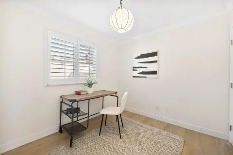 a view of a room with furniture and wooden floor