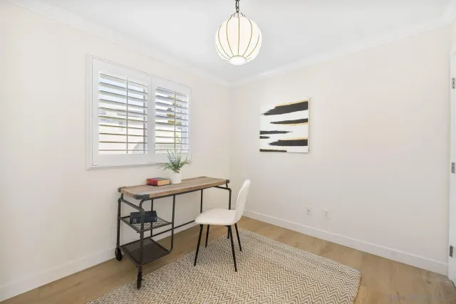 a view of a room with furniture and wooden floor