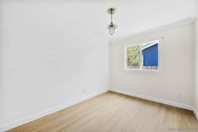 a view of a room with a window and a ceiling fan
