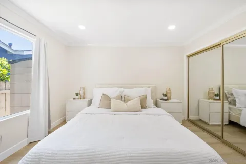 a bedroom with a bed and a large window