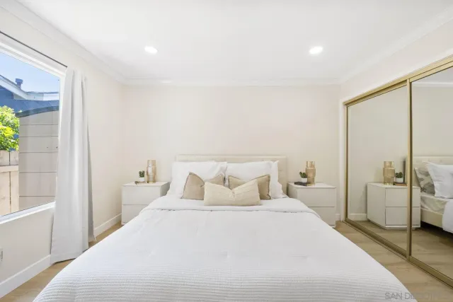 a bedroom with a bed and a large window