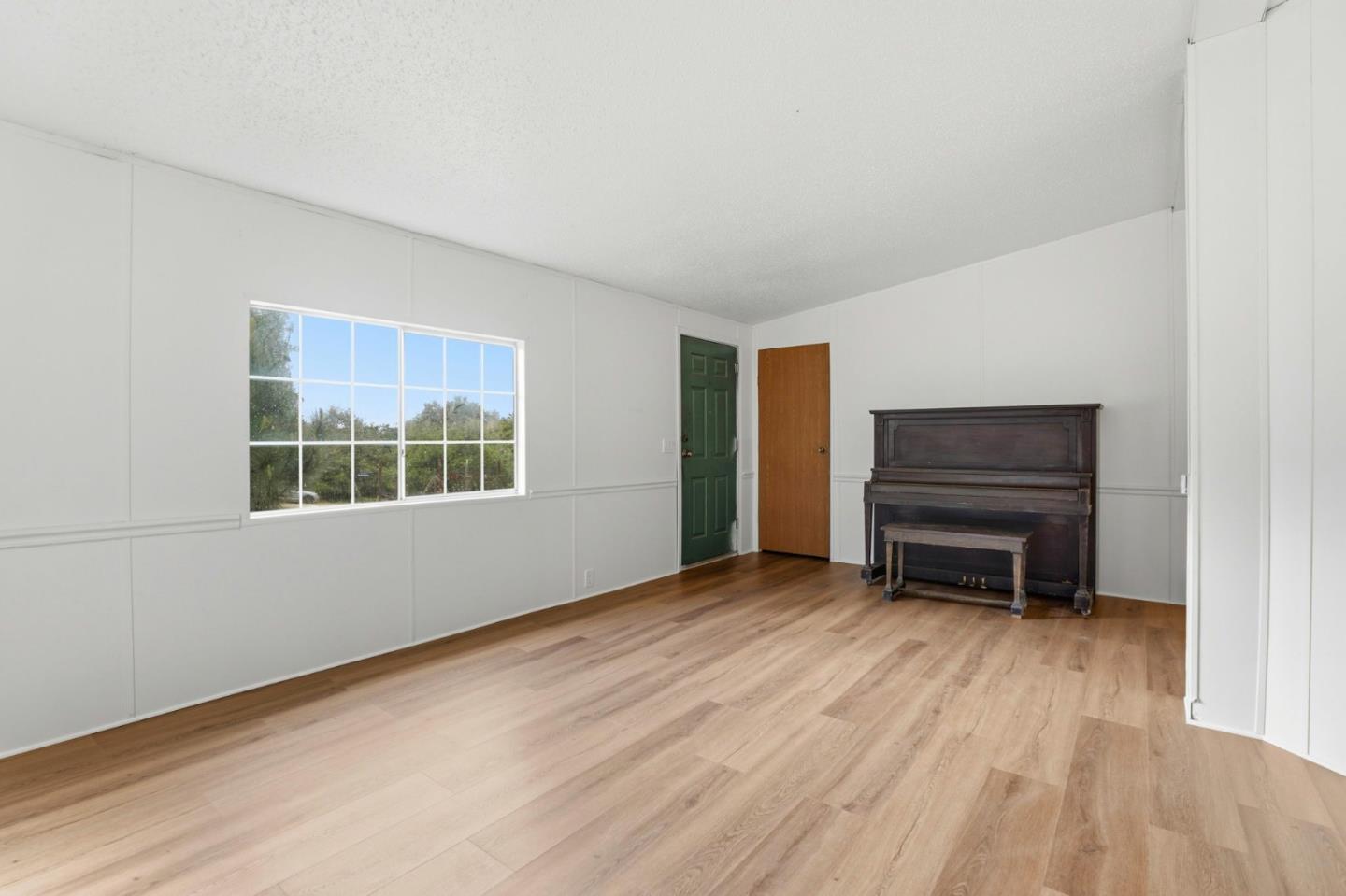 41800 Tassajara Road Carmel Valley, CA 93924 - Photo 19 of 51 a view of an empty room with a window and wooden floor