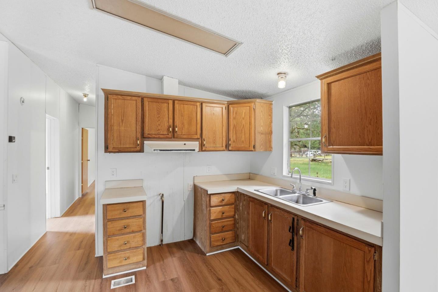 41800 Tassajara Road Carmel Valley, CA 93924 - Photo 21 of 51 a kitchen with a sink cabinets stainless steel appliances and a window
