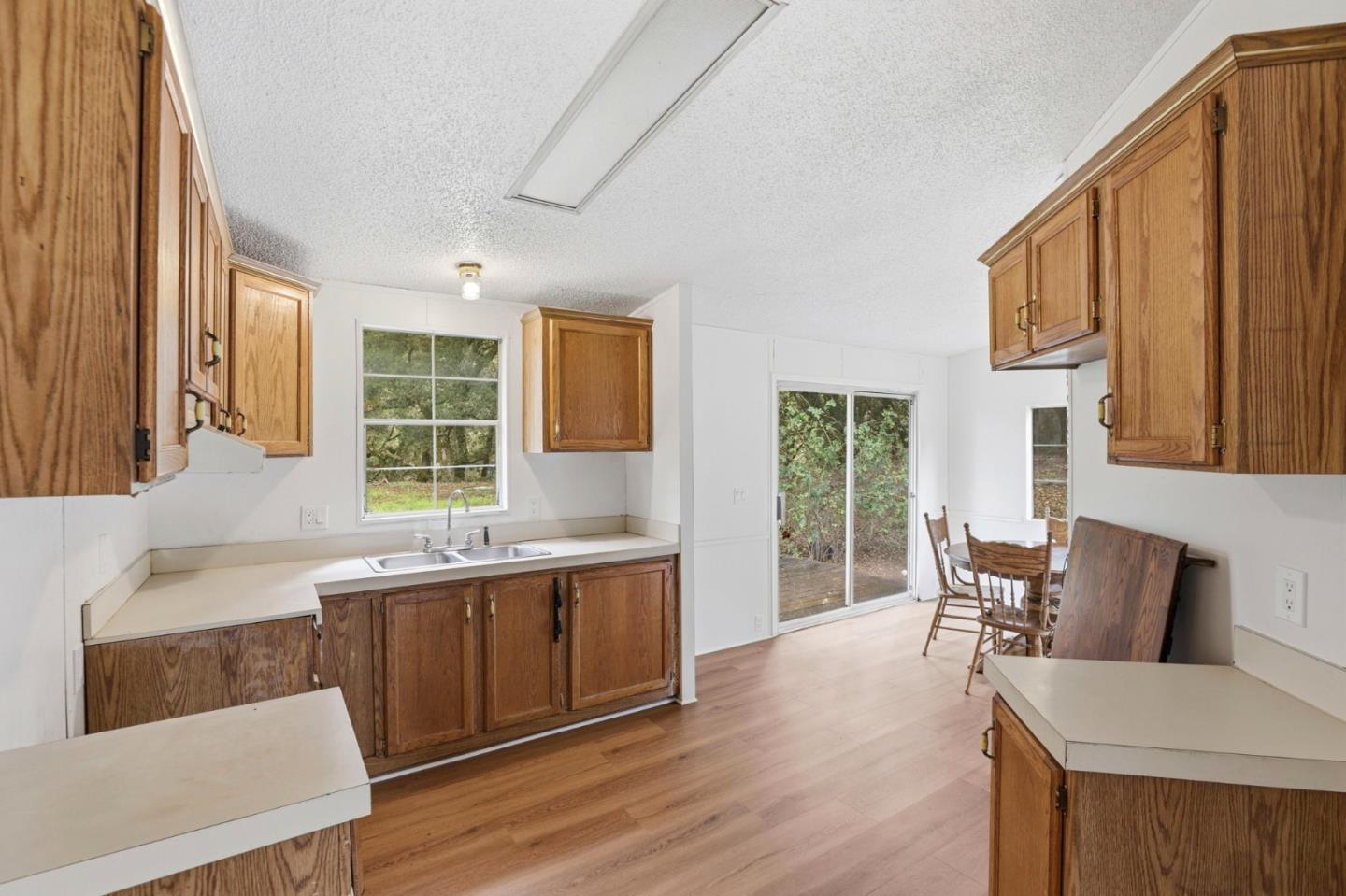 41800 Tassajara Road Carmel Valley, CA 93924 - Photo 23 of 51 a view of a kitchen with kitchen island granite countertop a sink and a stove top oven