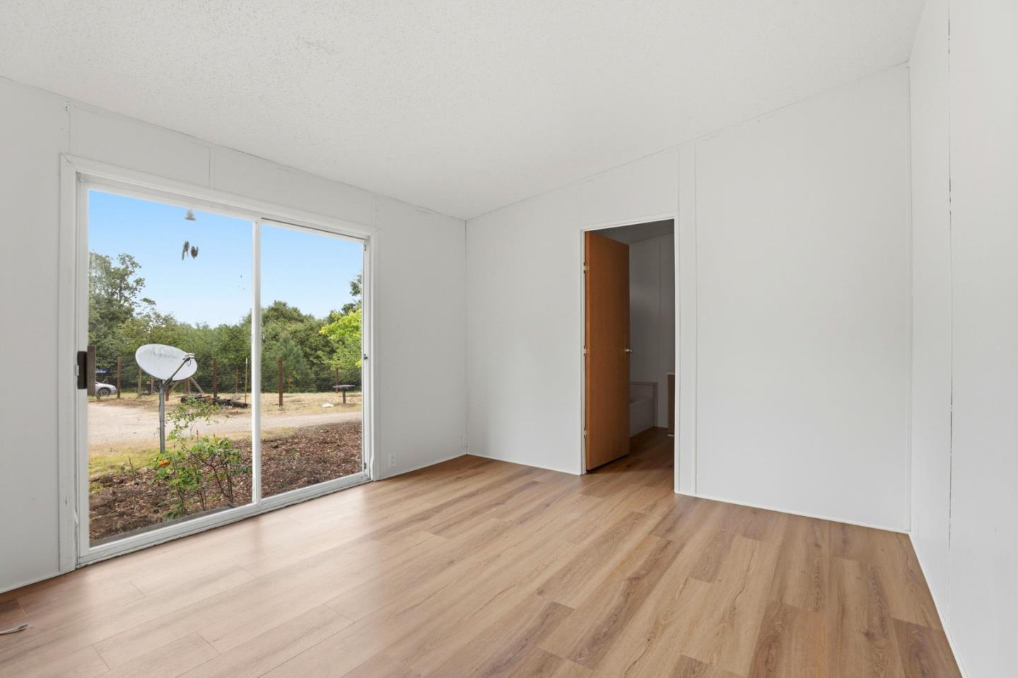 41800 Tassajara Road Carmel Valley, CA 93924 - Photo 27 of 51 an empty room with wooden floor and windows