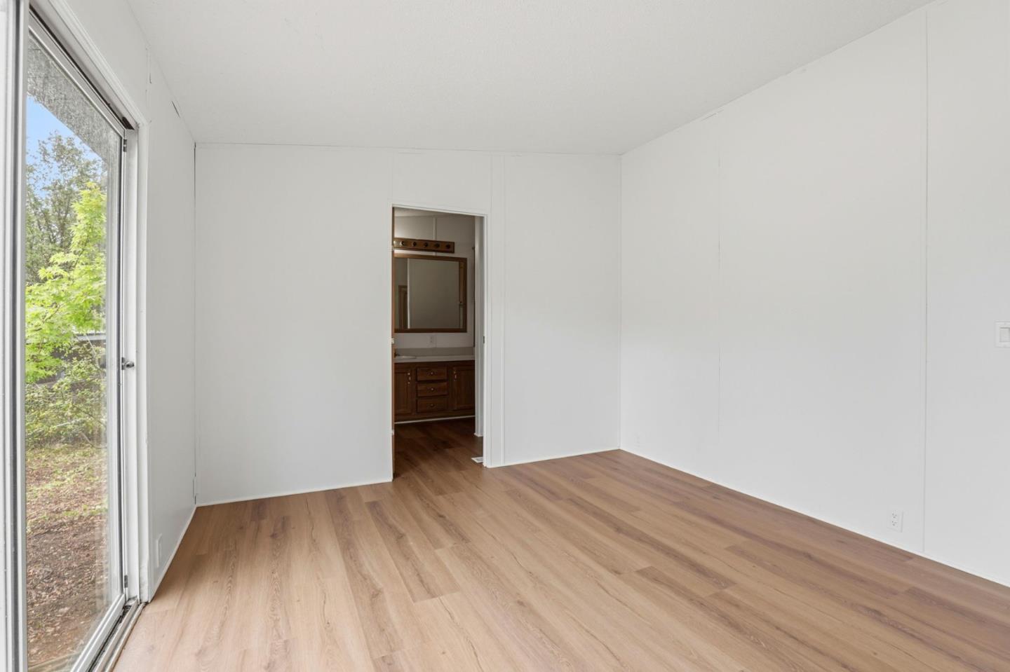 41800 Tassajara Road Carmel Valley, CA 93924 - Photo 28 of 51 an empty room with wooden floor and windows