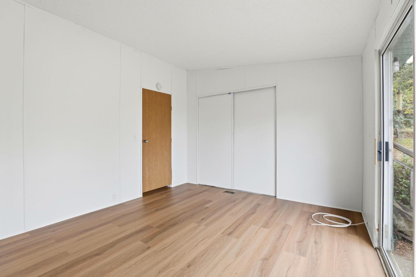 41800 Tassajara Road Carmel Valley, CA 93924 - Photo 29 of 51 an empty room with wooden floor and closet