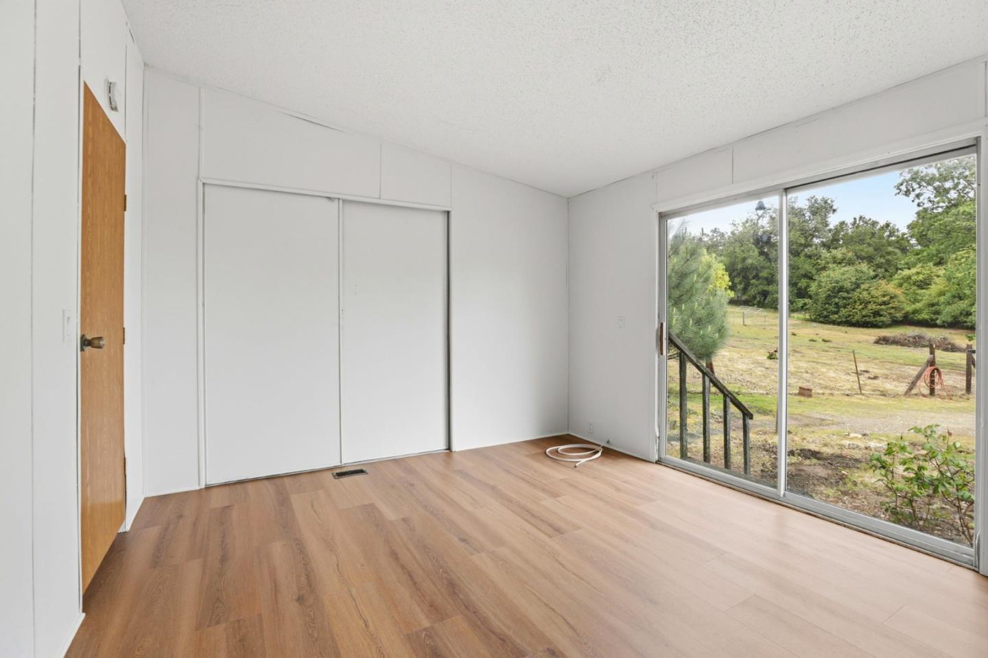 41800 Tassajara Road Carmel Valley, CA 93924 - Photo 30 of 51 a view of empty room with floor to ceiling window and wooden floor