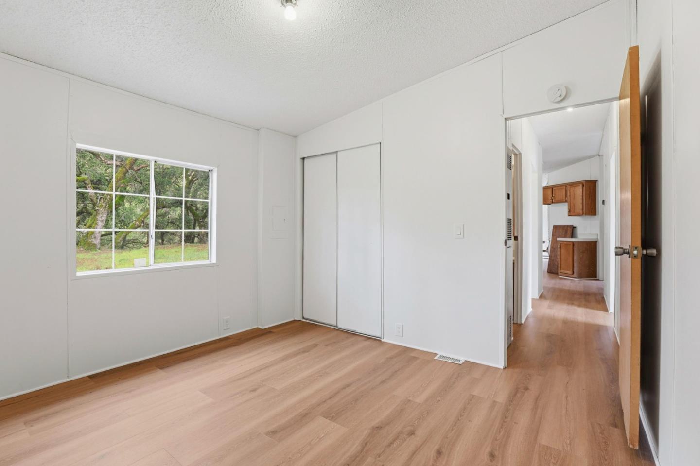 41800 Tassajara Road Carmel Valley, CA 93924 - Photo 32 of 51 an empty room with wooden floor and a window