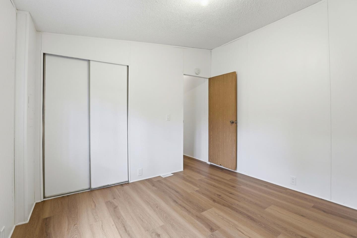 41800 Tassajara Road Carmel Valley, CA 93924 - Photo 33 of 51 an empty room with wooden floor and closet