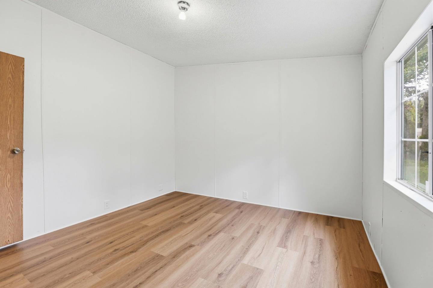 41800 Tassajara Road Carmel Valley, CA 93924 - Photo 34 of 51 an empty room with wooden floor and windows
