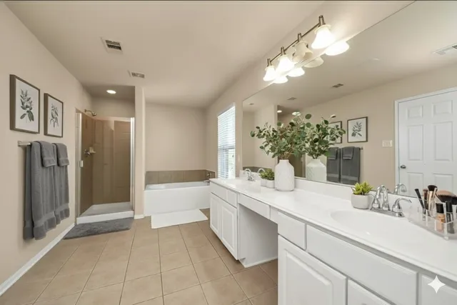 a spacious bathroom with a granite countertop sink a mirror and a bathtub