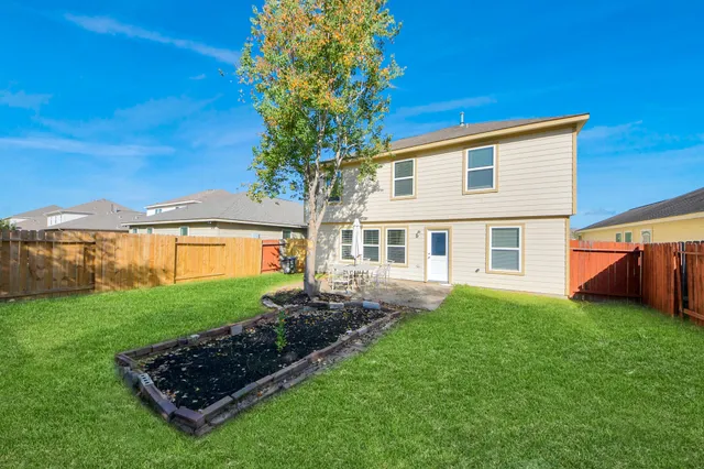 a view of a house with pool and a yard