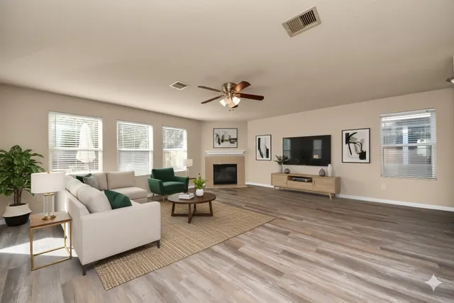 a living room with furniture a fireplace and a flat screen tv