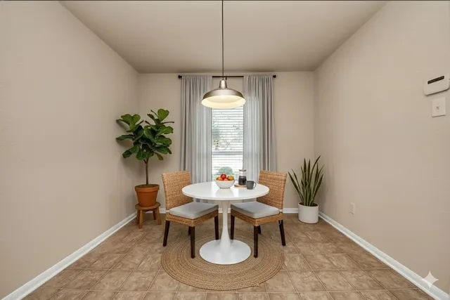 a dining room with furniture and window