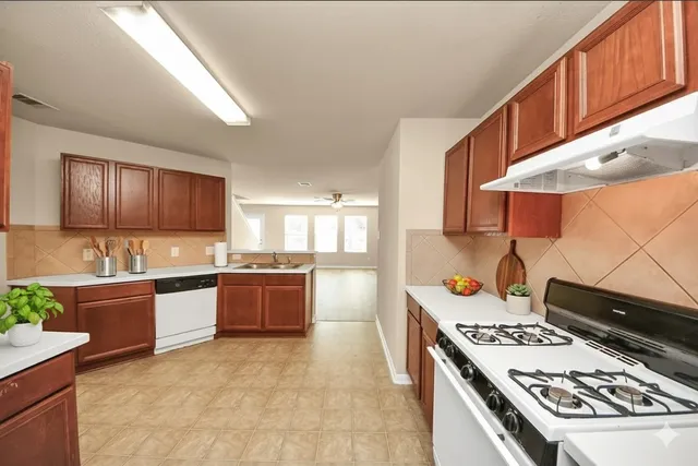 a kitchen with a stove and a refrigerator