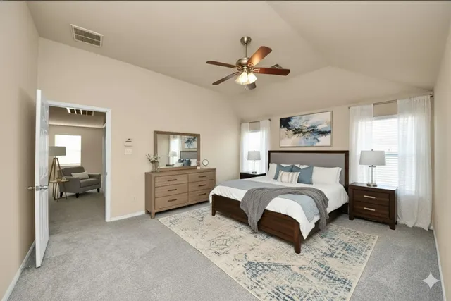 a bedroom with a bed and ceiling chandelier