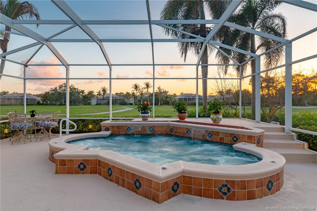 2216 Southeast Stonehaven Road Port St. Lucie, FL 34952 - Photo 6 of 67 a view of a swimming pool with lawn chairs and a big yard
