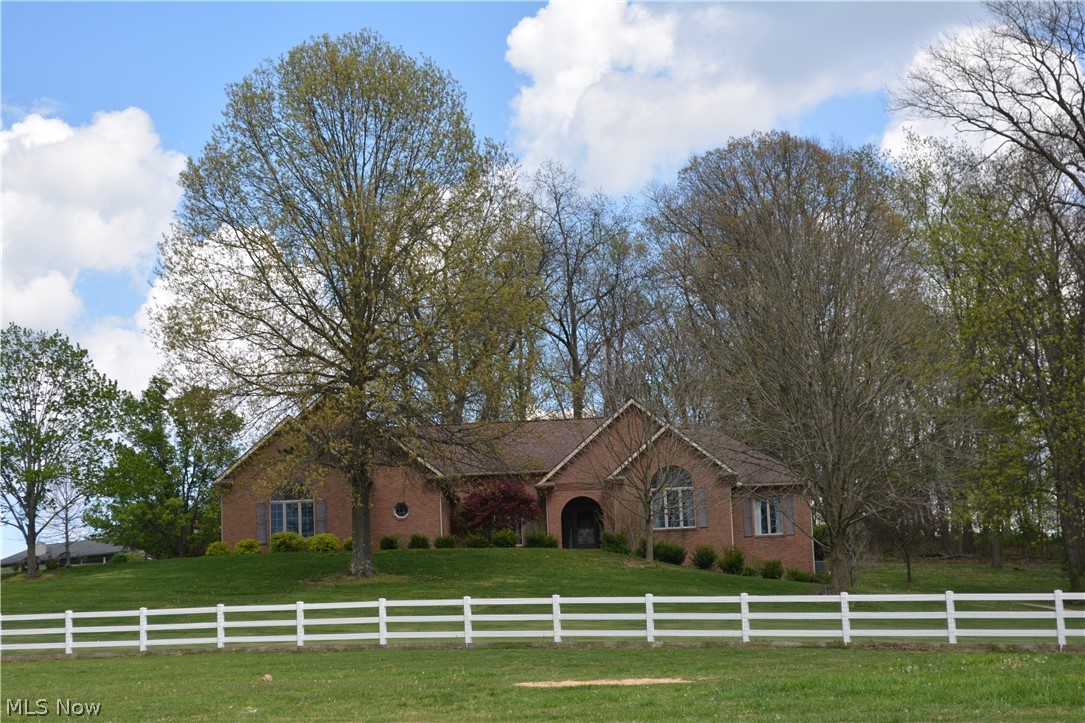 2363 Tabor Ridge Road Northeast New Philadelphia, OH 44663 - Photo 3 of 42 Brick exterior residence set on a gently sloping, landscaped lot