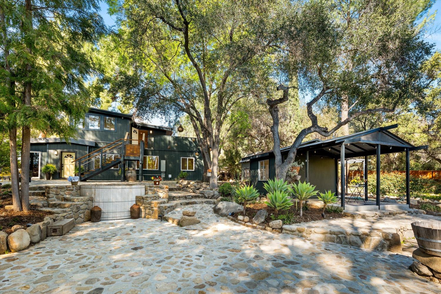 3541 Thacher Road Ojai, CA 93023 - Photo 26 of 50 a view of a patio with table and chairs under an umbrella