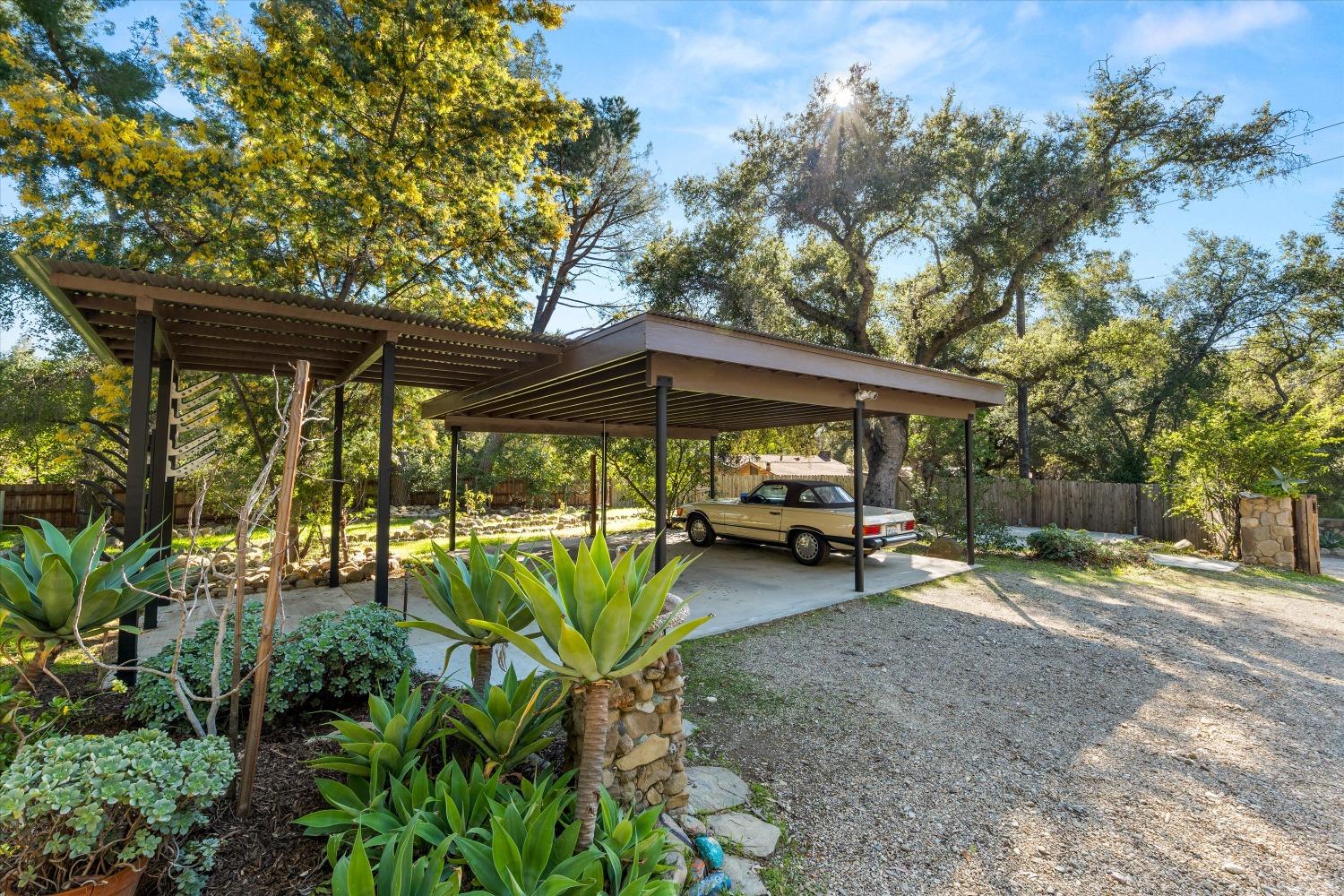 3541 Thacher Road Ojai, CA 93023 - Photo 44 of 50 a view of a patio with table and chairs under an umbrella with a large tree