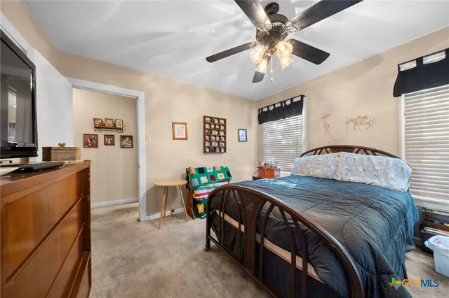 a bathroom with a sink vanity mirror and toilet