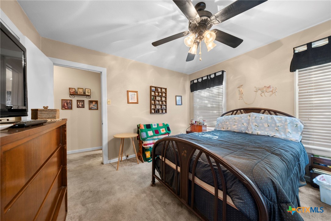 1213 North Main Street Temple, TX 76501 - Photo 11 of 37 a bedroom with a bed and a chandelier