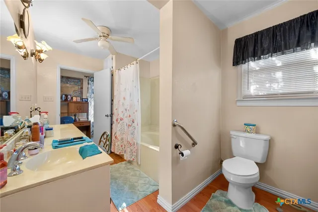 a bathroom with a tub sink and mirror