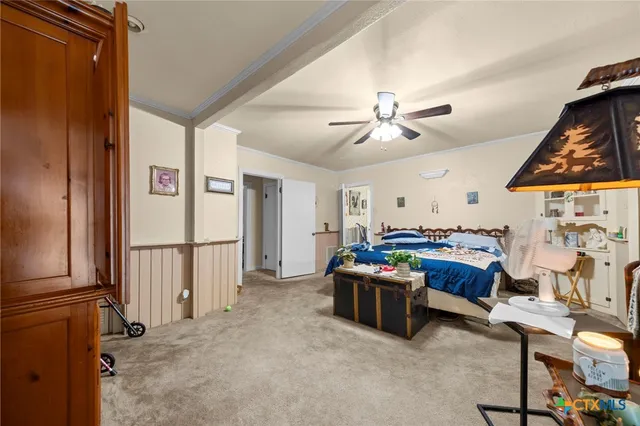 a bedroom with bed and a chandelier