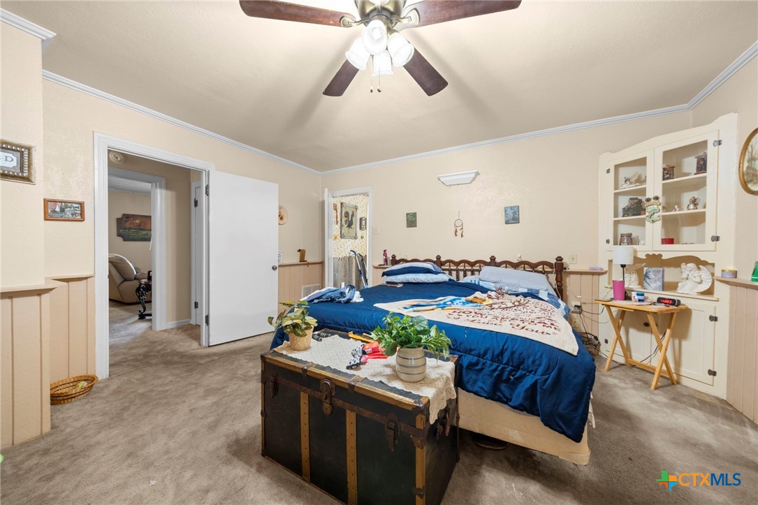 1213 North Main Street Temple, TX 76501 - Photo 17 of 37 a bedroom with bed and a chandelier