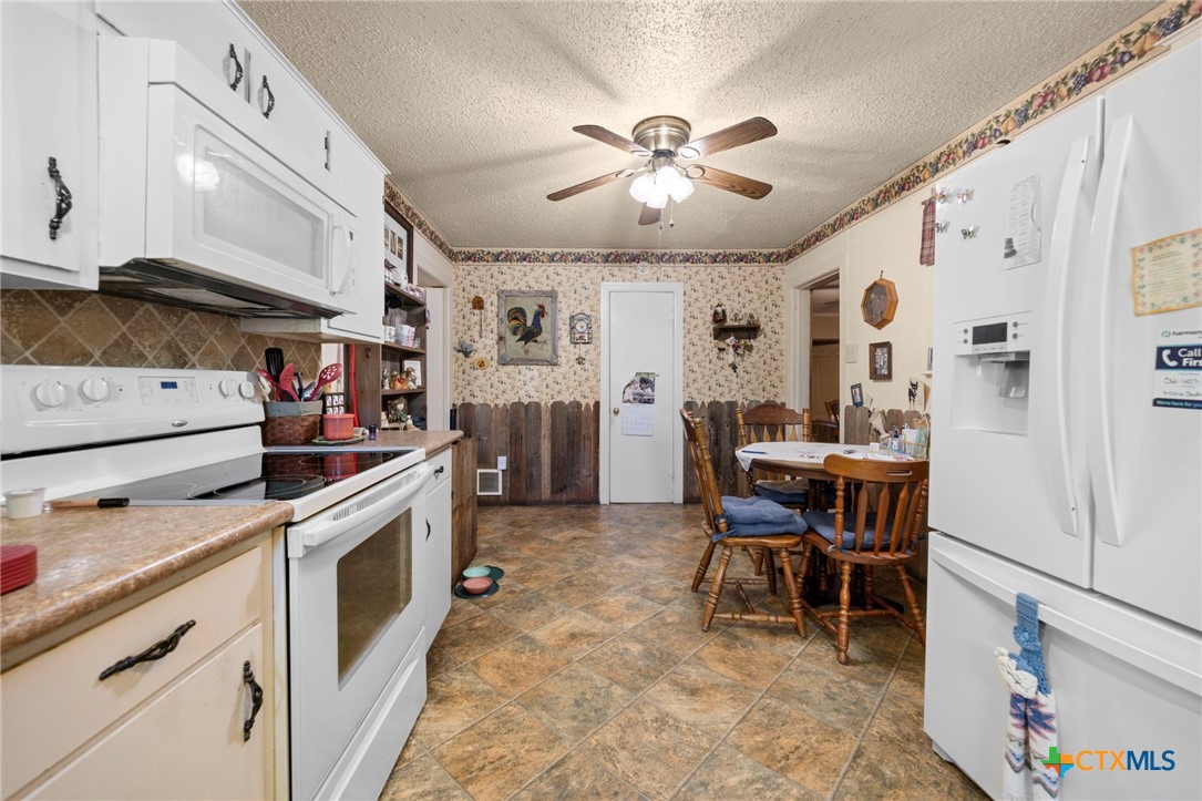 1213 North Main Street Temple, TX 76501 - Photo 22 of 37 a kitchen that has a lot of cabinets in it and appliances
