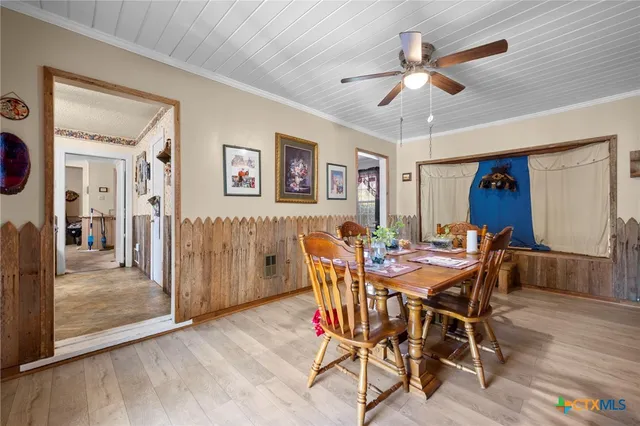 a view of a dining room with furniture and a chandelier
