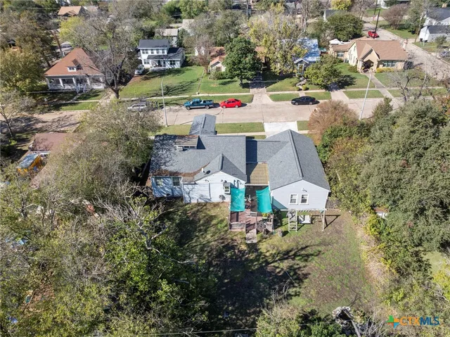 an aerial view of residential houses with outdoor space