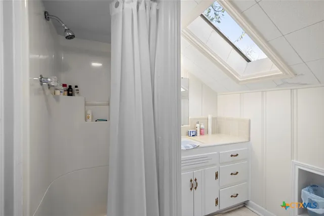 a bathroom with a granite countertop toilet a sink and mirror