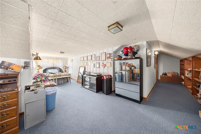 a bedroom with bed and a window