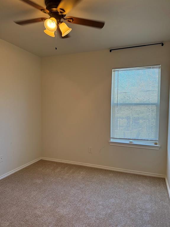 1221 Village Garden Azle, TX 76020 - Photo 20 of 23 an empty room with a window and a fan