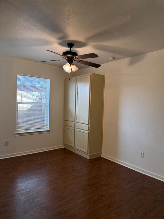 1221 Village Garden Azle, TX 76020 - Photo 7 of 23 a view of an empty room with wooden floor and a window