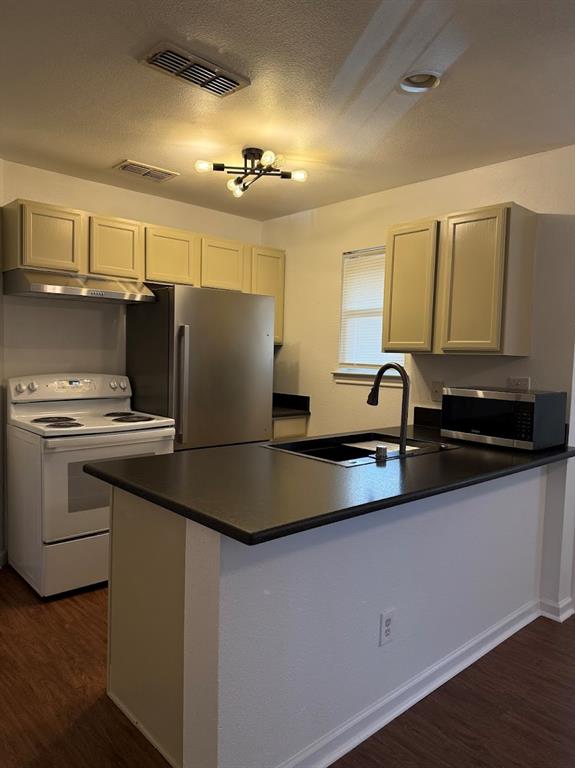 1221 Village Garden Azle, TX 76020 - Photo 8 of 23 a kitchen with stainless steel appliances a refrigerator sink and stove