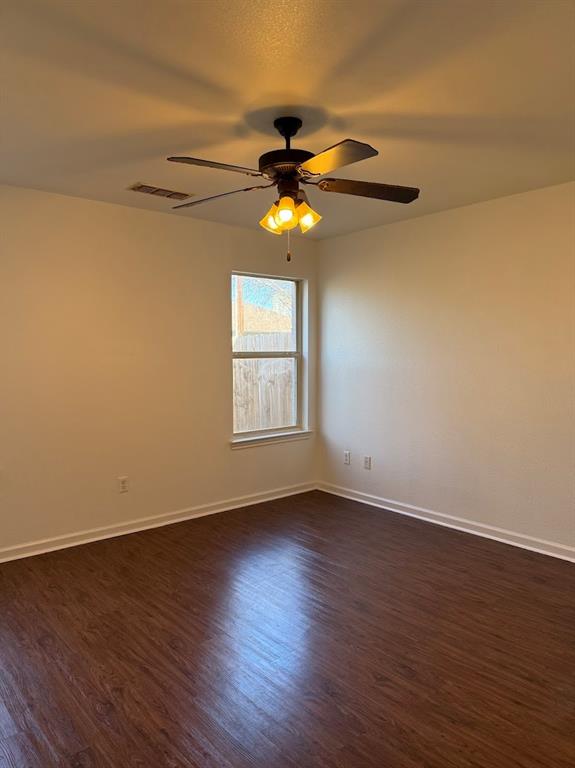 1221 Village Garden Azle, TX 76020 - Photo 9 of 23 a view of a livingroom with wooden floor a ceiling fan and window