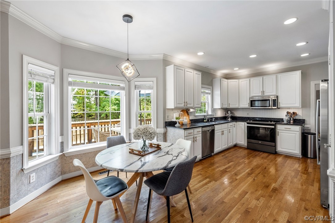 2540 Dunham Road Henrico, VA 23233 - Photo 11 of 40 a kitchen with refrigerator a sink and chairs